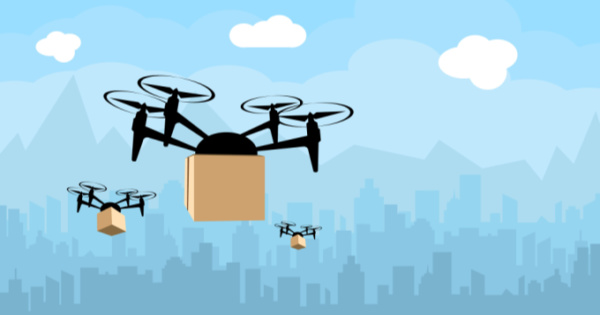 A vector image of drones carrying packages with a faded city-scape 